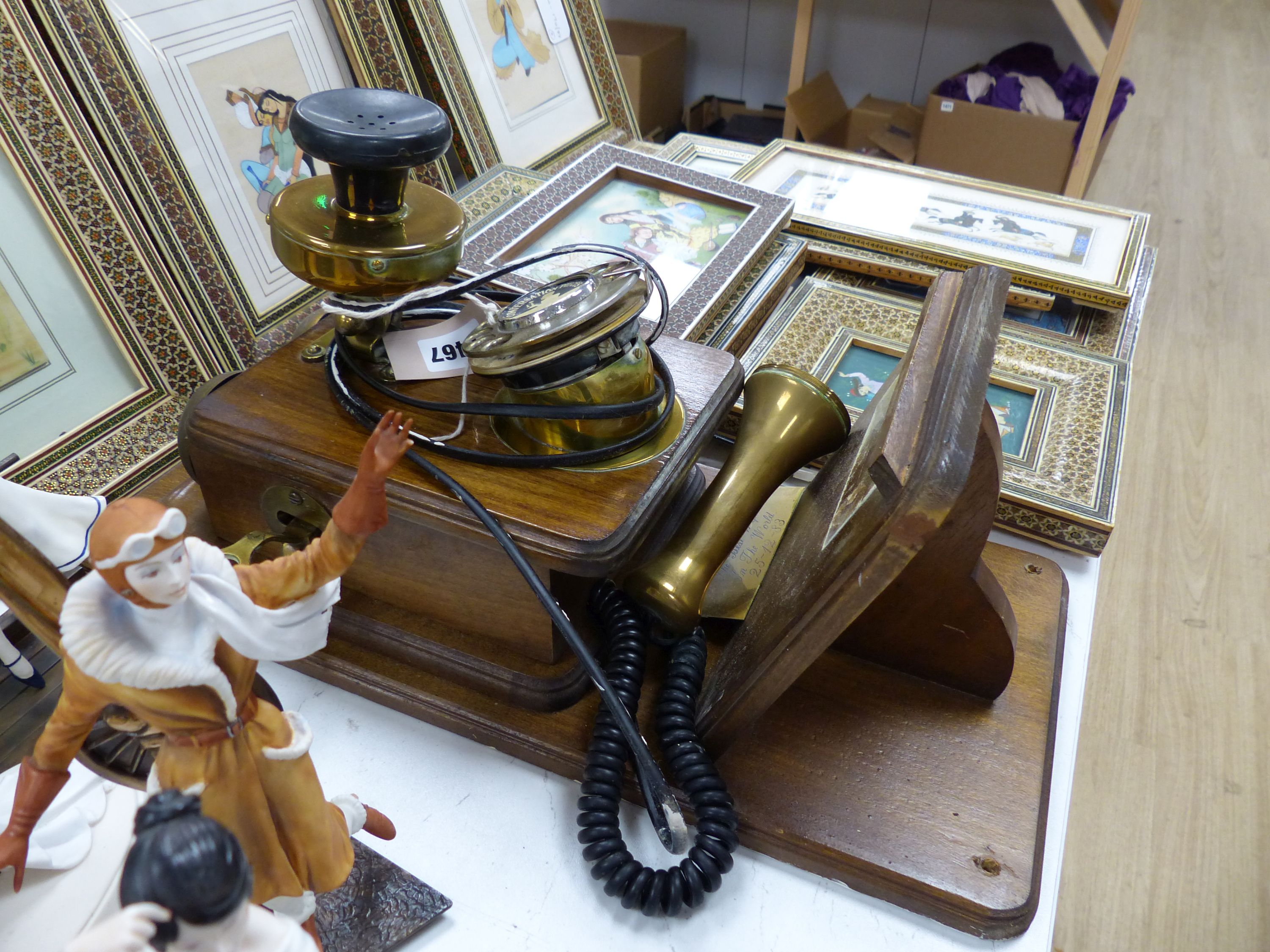 A vintage wood, brass and Bakelite wall-mounted telephone